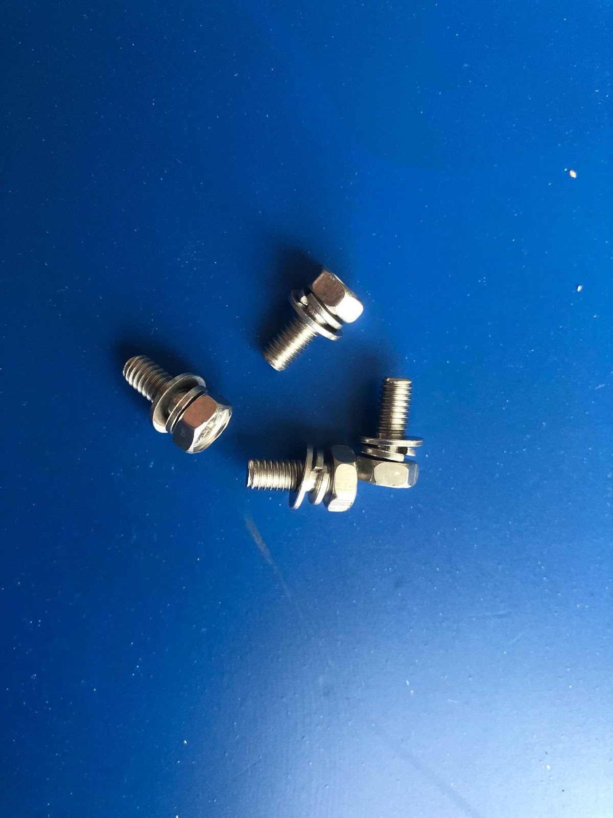 Four screws with washers